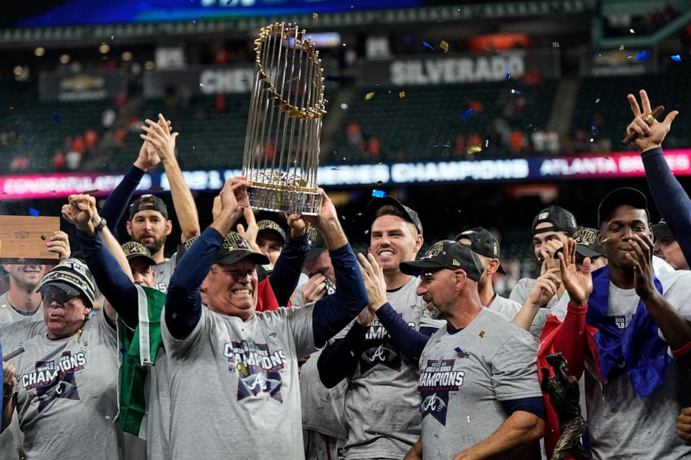 PHOTO: Atlanta Braves manager Brian Snitker holds up the trophy after winning baseball's World Series in Game 6 against the Houston Astros Tuesday, Nov. 2, 2021, in Houston. The Braves won 7-0.