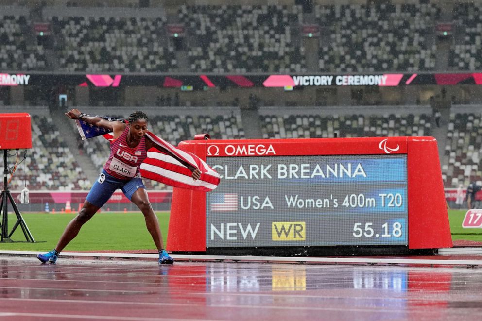 PHOTO: Breanna Clark of the United States celebrates next to the scoreboard showing her world record in the women's 400-meter T20 final during the Tokyo 2020 Paralympics Games at the National Stadium in Tokyo, Tuesday, Aug. 31, 2021.