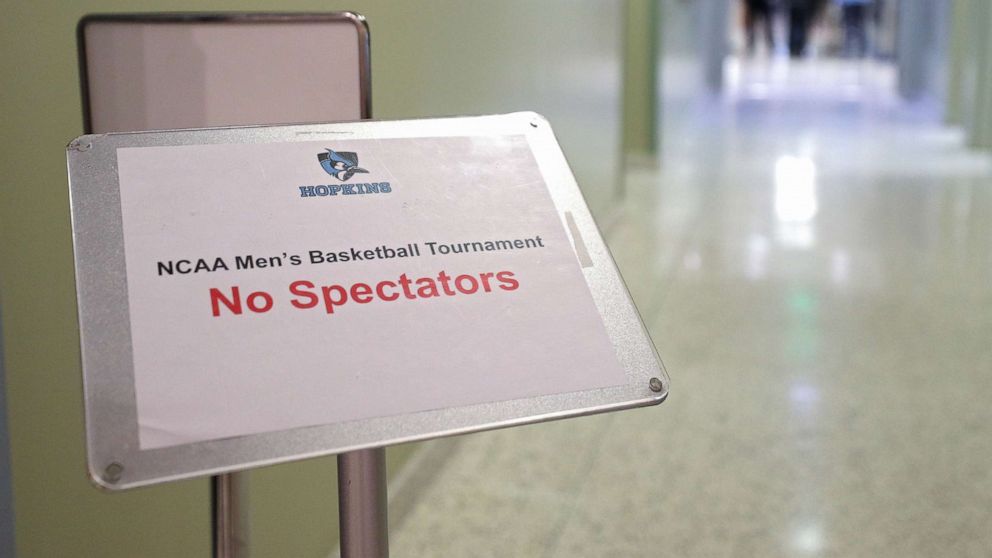 PHOTO: A sign reads 'No Spectators" prior to Yeshiva playing against Worcester Polytechnic Institute during the NCAA Division III Men's Basketball Championship, March 6, 2020, in Baltimore, Md.