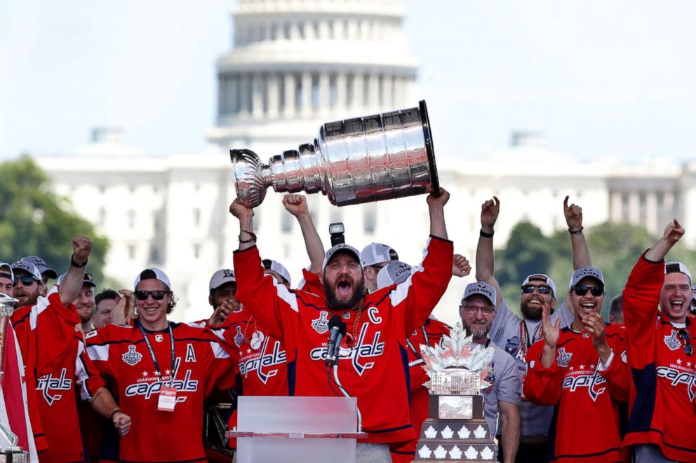 PHOTO: Washington Capitals Alex Ovechkin, from Russia, holds up the Stanley Cup trophy during the NHL hockey team's Stanley Cup victory celebration, June 12, 2018, at the National Mall in Washington.