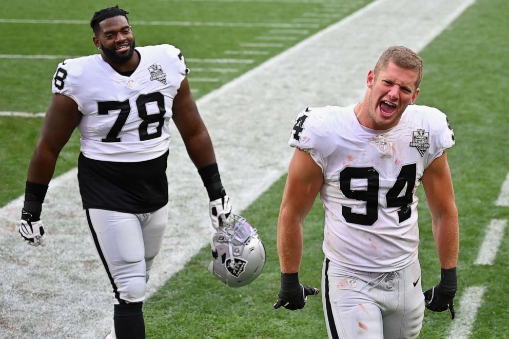 PHOTO: Defensive end Carl Nassib, right, and offensive guard Patrick Omameh of the Las Vegas Raiders celebrate as they walks off the field following the NFL game against the Cleveland Browns at FirstEnergy Stadium on Nov. 01, 2020, in Cleveland.