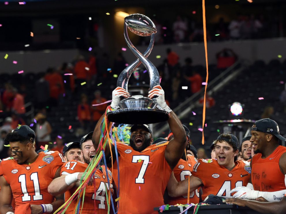 PHOTO: Clemson defensive end Austin Bryant (7) holds up the trophy as the team celebrates their 30-3 win against Notre Dame in the NCAA Cotton Bowl semi-final playoff football game, Saturday, Dec. 29, 2018, in Arlington, Texas.