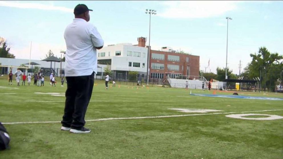 PHOTO: Coach Steve Zanders watches over his team on the Woodland Tigers football field in Southeast, Washington, D.C.
