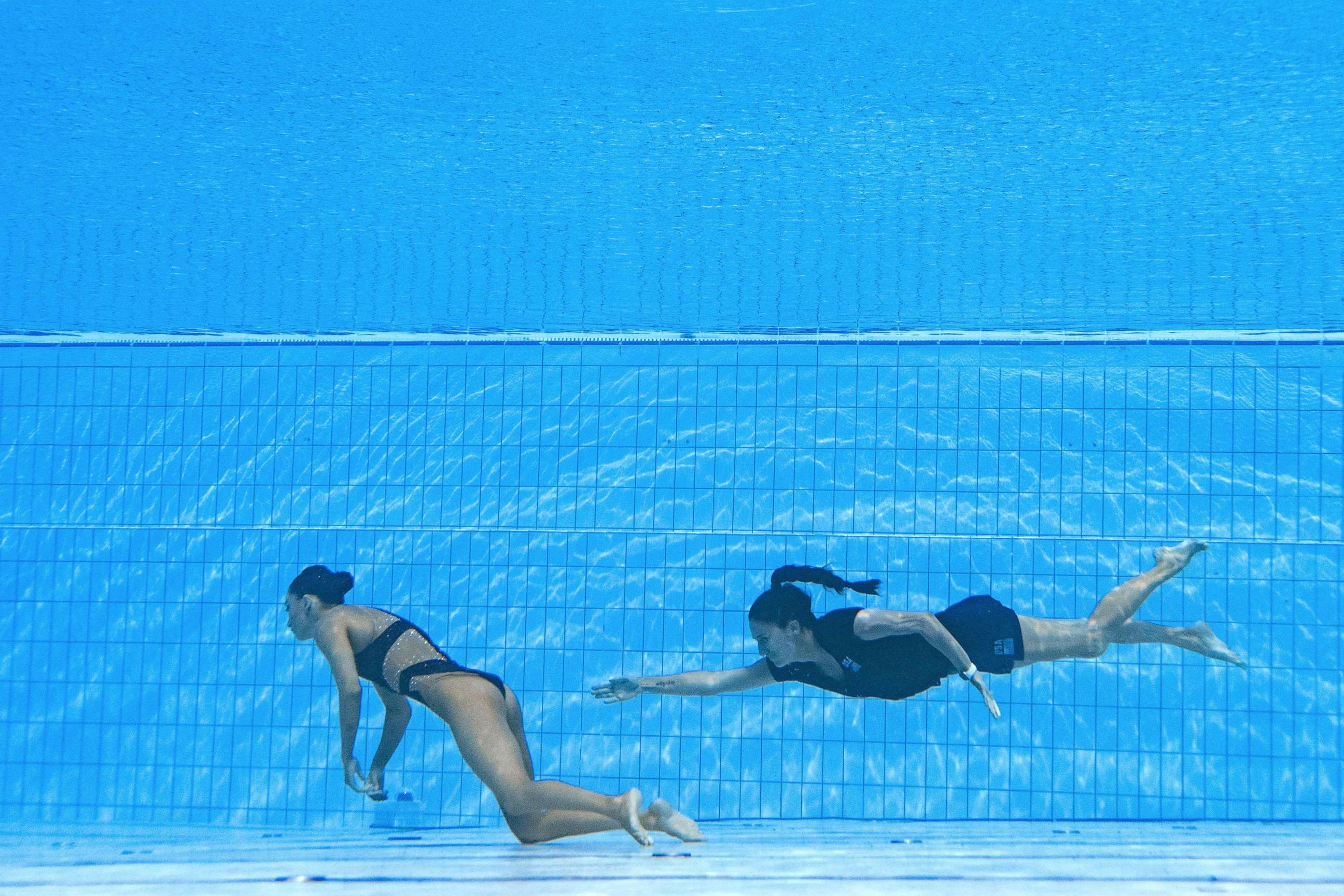PHOTO: A member of Team USA swims to recover USA's Anita Alvarez, from the bottom of the pool during an incident in the women's solo free artistic swimming finals, during the Budapest 2022 World Aquatics Championships in Budapest on June 22, 2022.