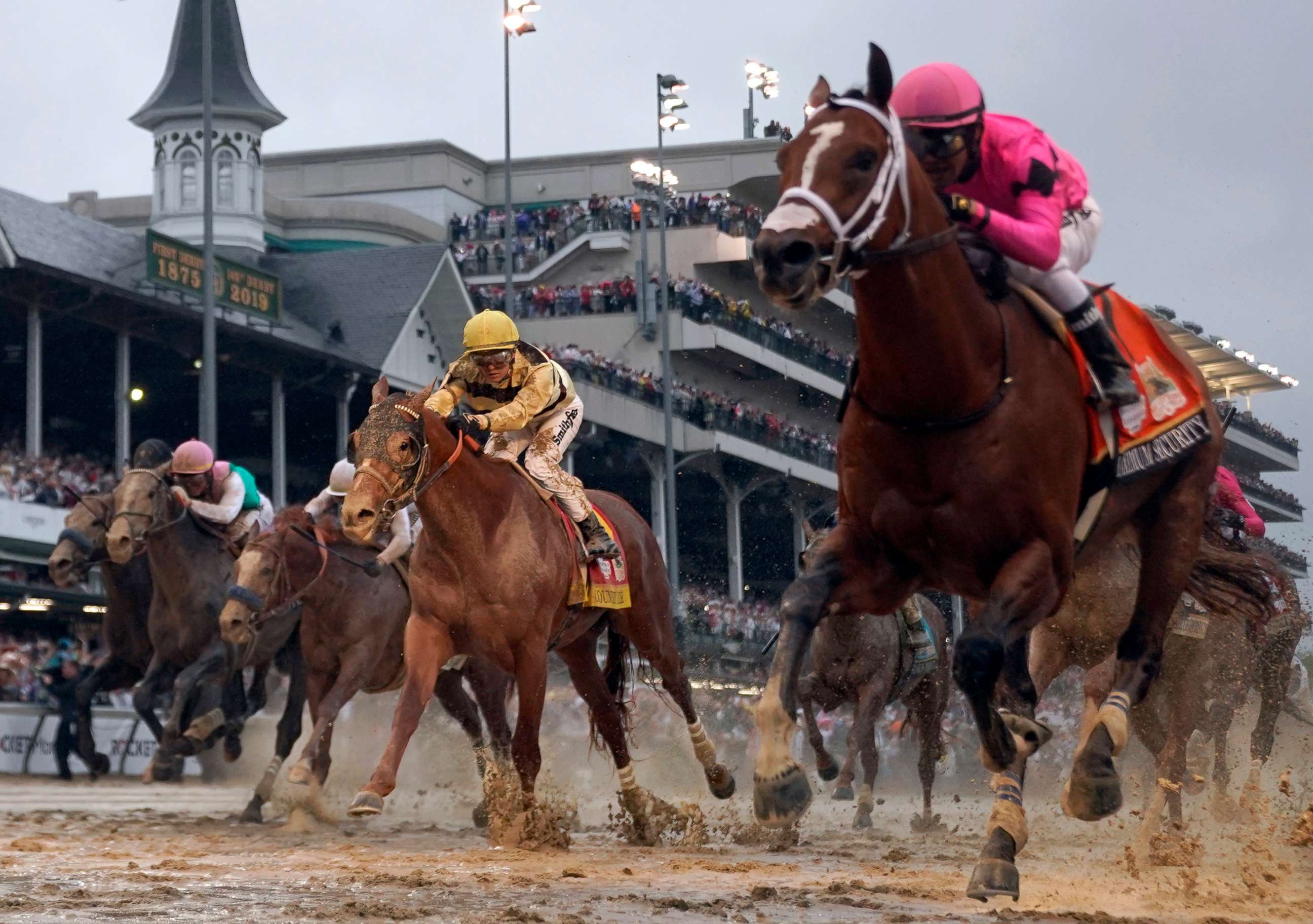 PHOTO: Luis Saez rides Maximum Security, right, across the finish line first as Flavien Prat on Country House comes in behind, center, during the Kentucky Derby at Churchill Downs, May 4, 2019, in Louisville, Ky. 