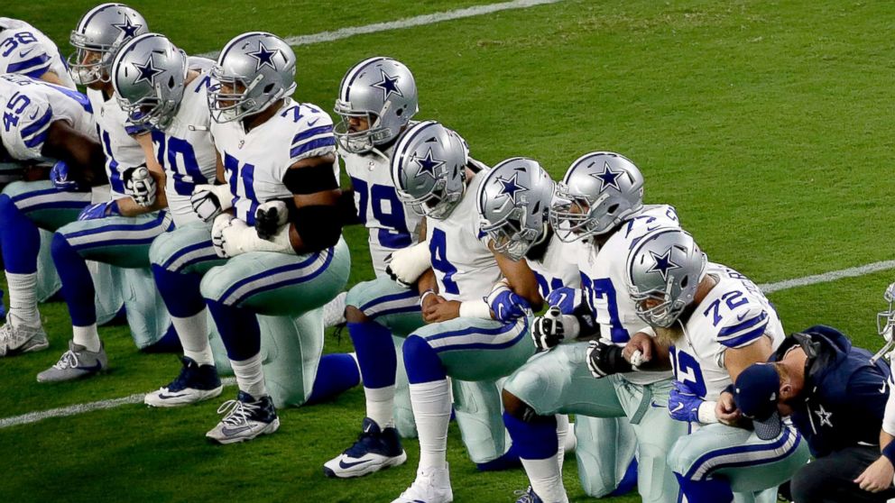 PHOTO: The Dallas Cowboys take a knee prior to the national anthem prior to an NFL football game against the Arizona Cardinals, Sept. 25, 2017, in Glendale, Ariz. 