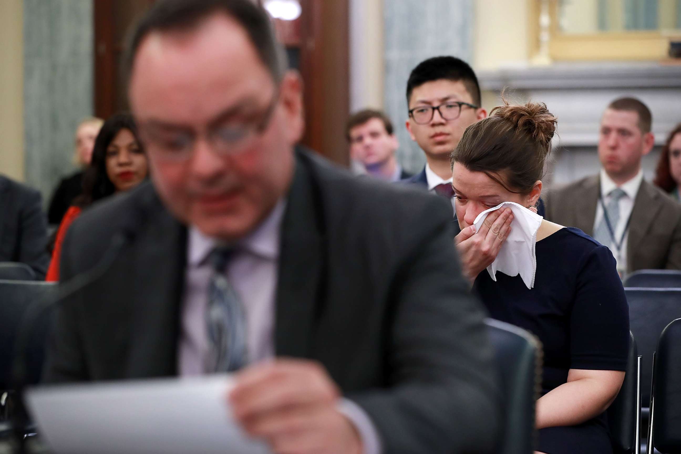 PHOTO: A woman weeps while listening to figure skater Craig Maurizi recount his sexual abuse at the hands of his coach when he was 13 years old while testifying before a Senate subcommittee on Capitol Hill April 18, 2018 in Washington.