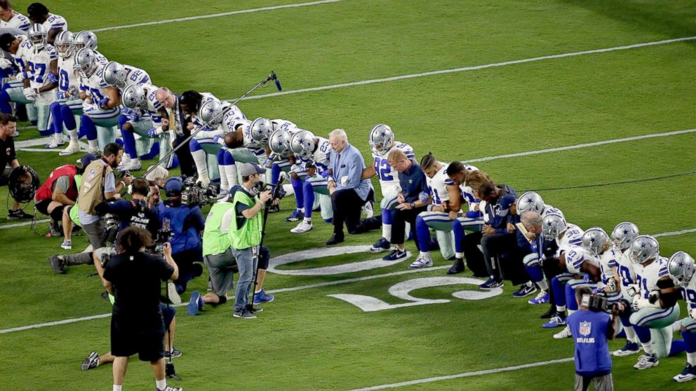 PHOTO: The Dallas Cowboys, led by owner Jerry Jones, center, take a knee prior to the national anthem prior to an NFL football game against the Arizona Cardinals, Sept. 25, 2017, in Glendale, Ariz.