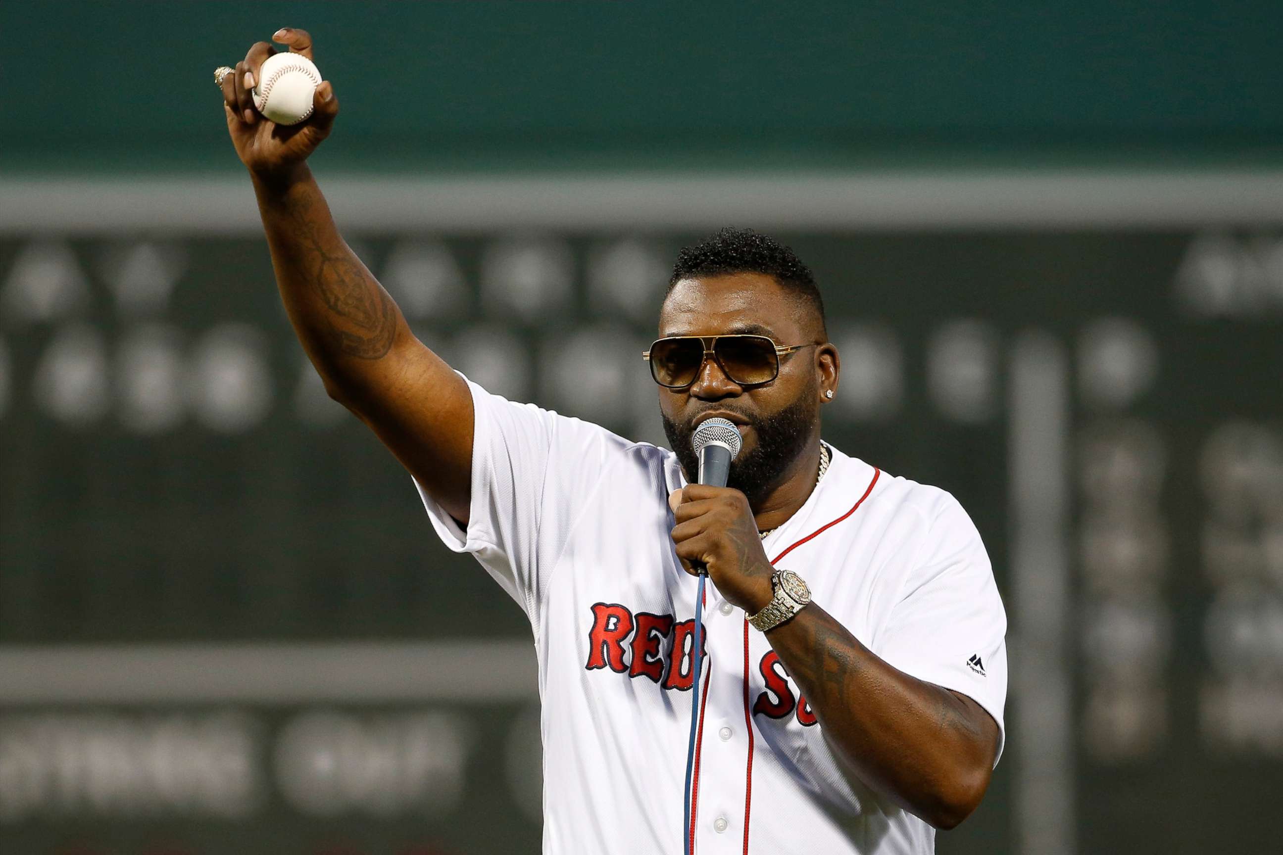 PHOTO: Former Boston Red Sox player David Ortiz talks to the crowd after throwing out the ceremonial first pitch before the game against the New York Yankees at Fenway Park in Boston, Sep 9, 2019.