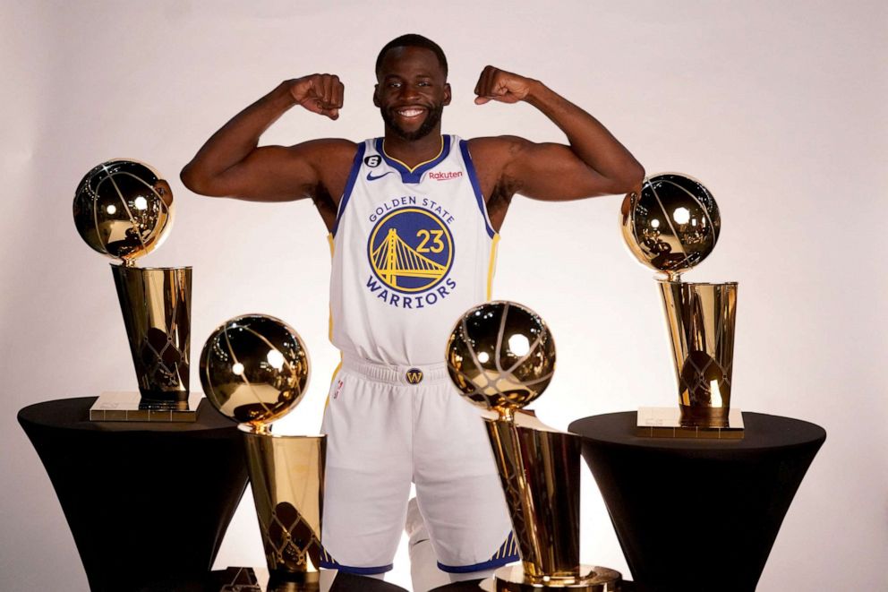PHOTO: Sep 25, 2022; San Francisco, CA, USA; Golden State Warriors forward Draymond Green (23) poses with the Larry O'Brien Championship Trophies during Media Day at the Chase Center.