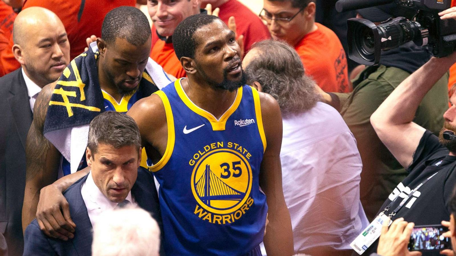 PHOTO: Golden State Warriors forward Kevin Durant glances up at the stands as he walks off the court after sustaining an injury during first half basketball action in Game 5 of the NBA Finals in Toronto, June 10, 2019.