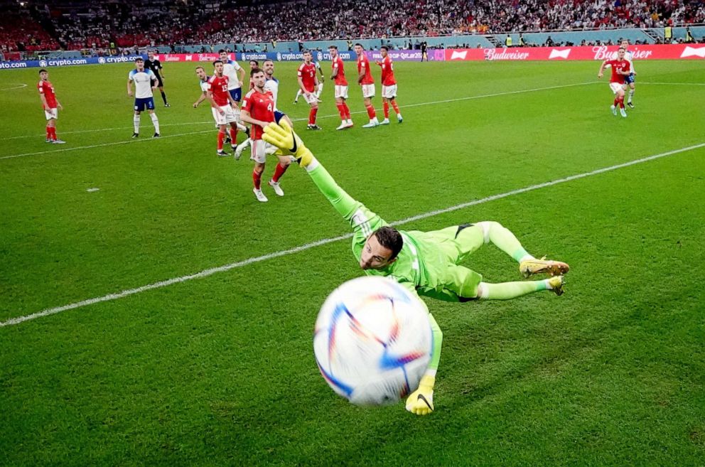 PHOTO: England's Marcus Rashford scores their first goal from a free kick past Wales' Danny Ward in the World Cup, Nov. 29, 2022.