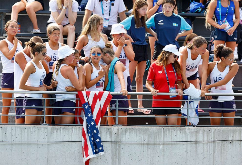 PHOTO: Members of the United States team react as swimmer Anita Alvarez receives medical attention during the women's solo free final at the FINA World Championships in Budapest, Hungary, on June 22, 2022. 