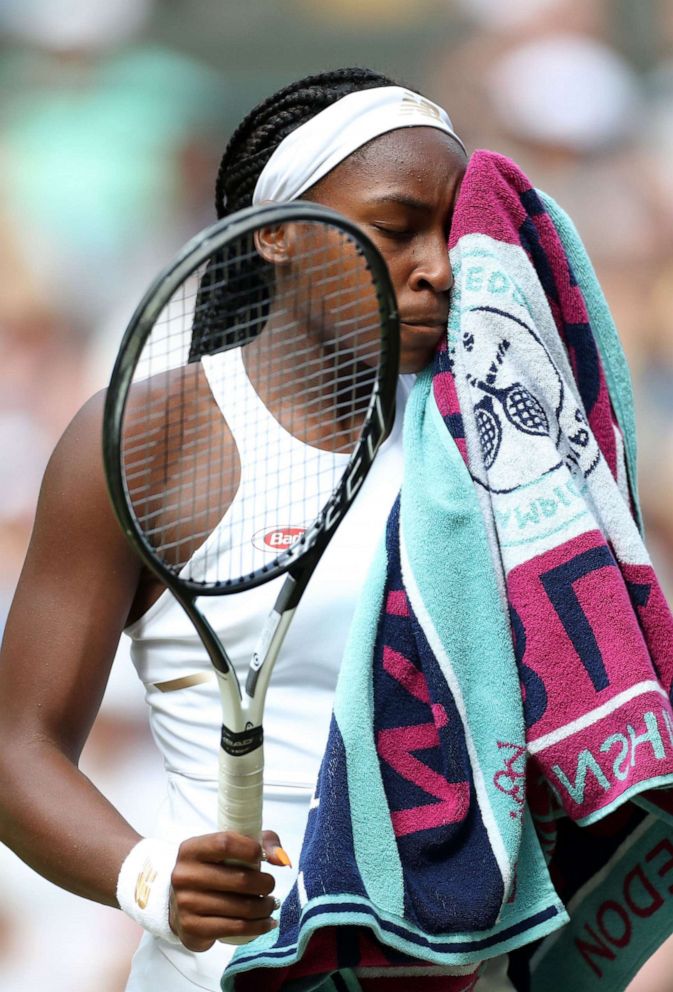 PHOTO: Cori Gauff wipes her face following her defeat in her Ladies' Singles fourth round match at Wimbledon to Romania's Simona Halep, in London, July 8, 2019.