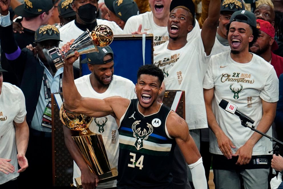 PHOTO: Milwaukee Bucks forward Giannis Antetokounmpo celebrates with the NBA Finals MVP trophy after defeating the Phoenix Suns in Game 6 of the NBA Finals in Milwaukee, Tuesday, July 20, 2021.