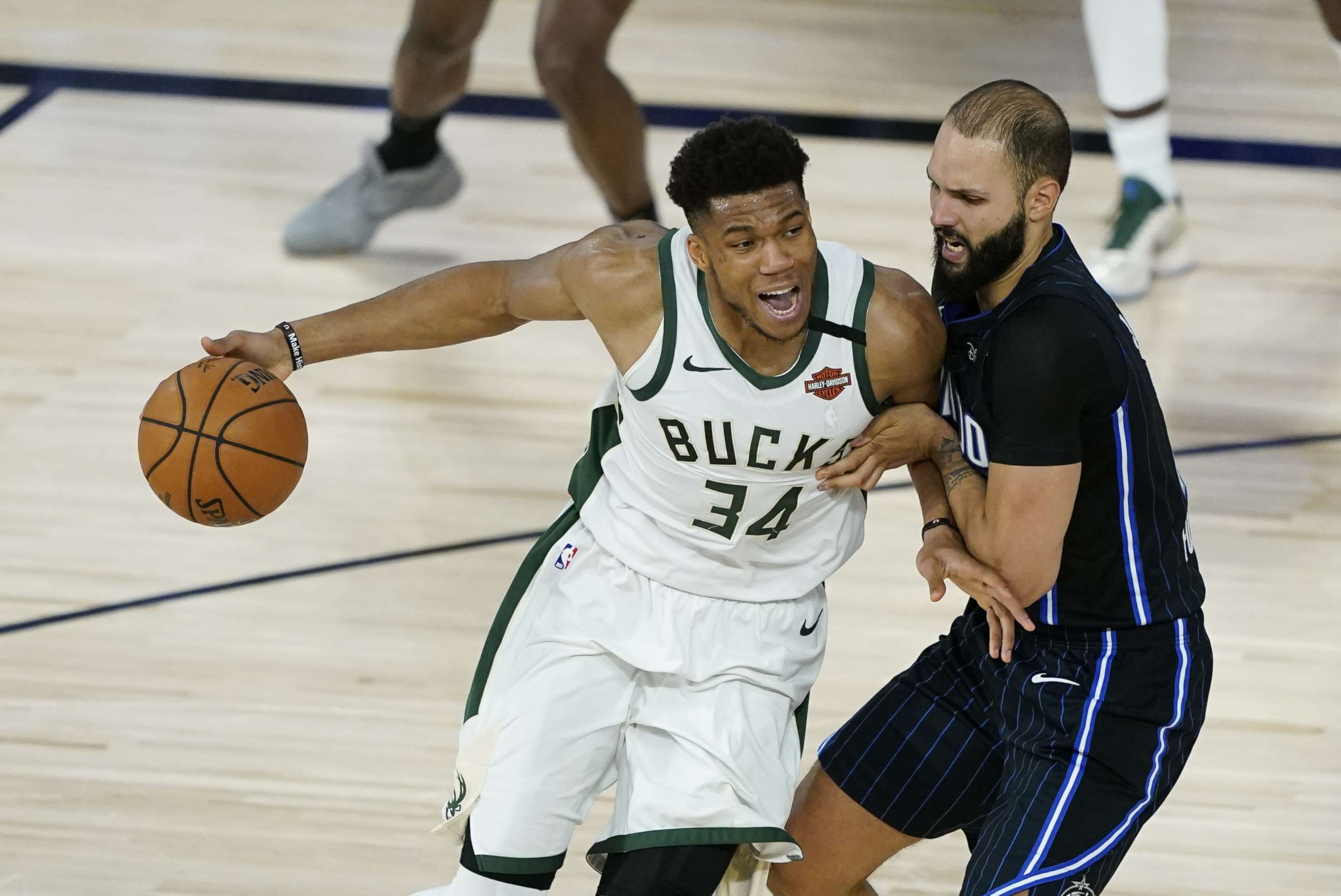 PHOTO: Giannis Antetokounmpo of the Milwaukee Bucks drives past Evan Fournier of the Orlando Magic during the second half of an NBA basketball first round playoff game on Aug. 24, 2020 in Lake Buena Vista, Fla.