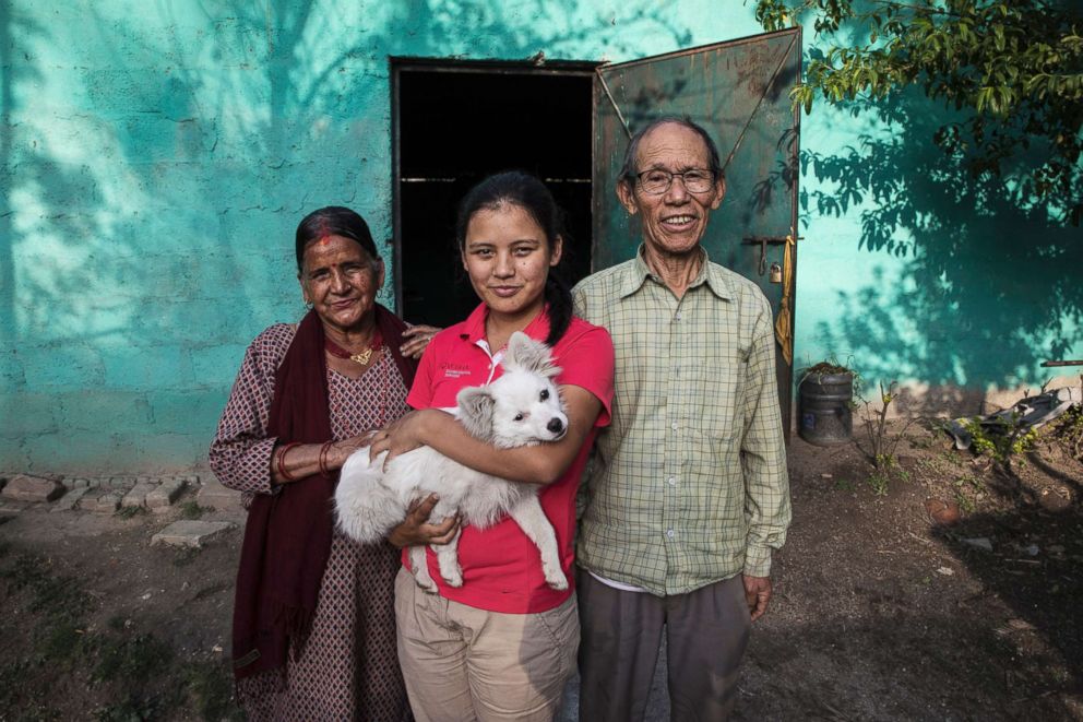 PHOTO: Pratima hopes that her golf career will make her parents proud. She poses with her father Pasang Sherpa and  her mother Keshav Kumari Ghimire, and their puppy Kiki.