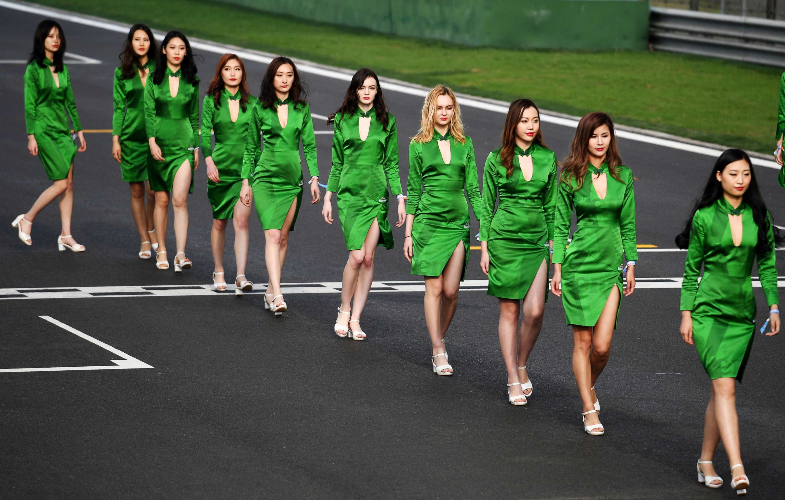 PHOTO: Grid girls walk on the track after the qualifying session for the Formula One Chinese Grand Prix in Shanghai, April 8, 2017.