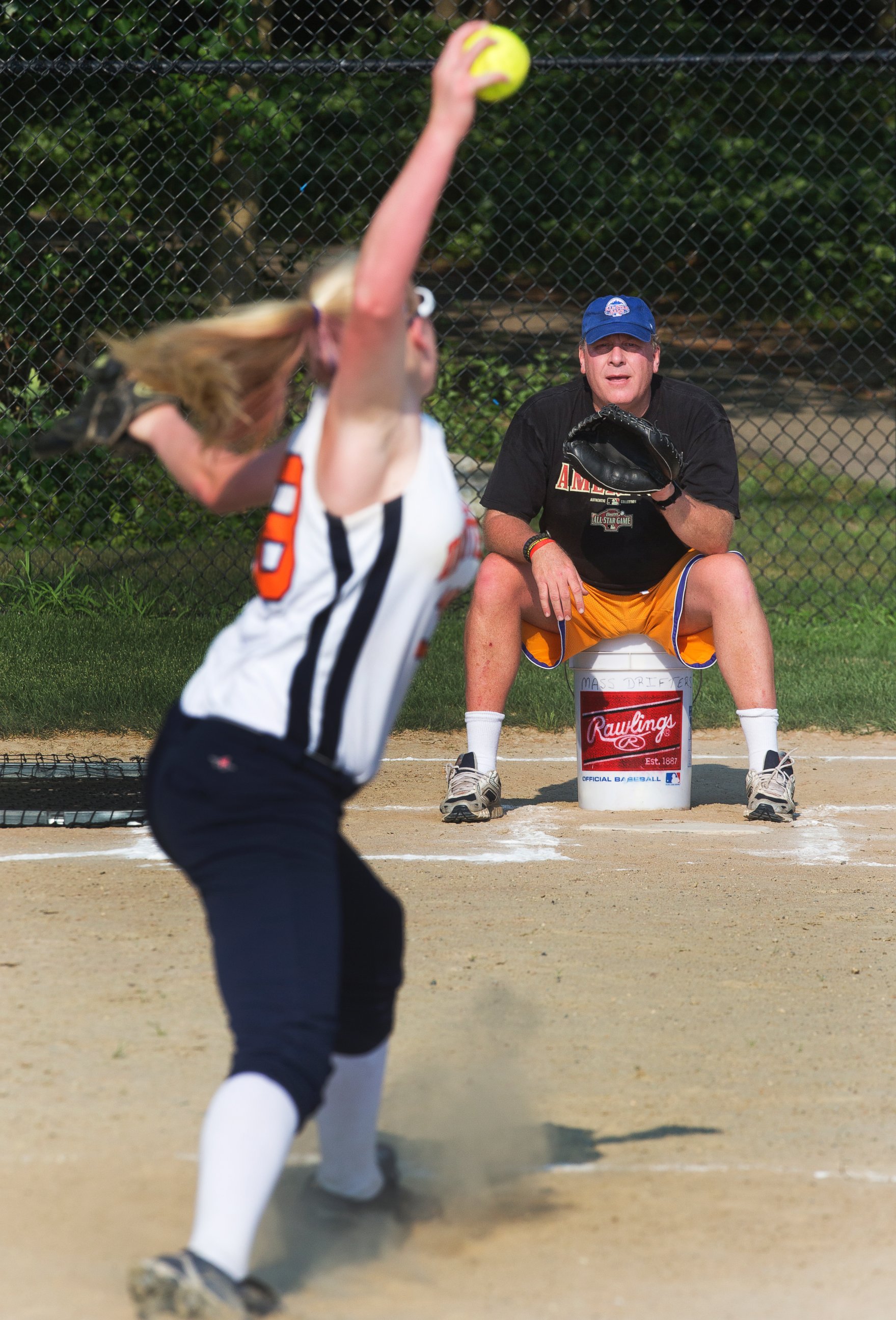 PHOTO: Curt Schilling, coach of the Drifters, a 16-and-under girls softball team, catches his daughter Gabby at Shonda Schilling Field in Medfield, Ma. on July 19, 2013.