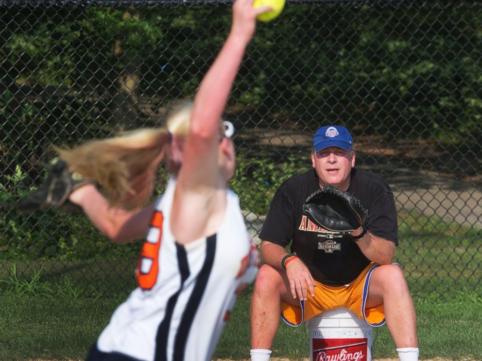 PHOTO: Curt Schilling, coach of the Drifters, a 16-and-under girls softball team, catches his daughter Gabby at Shonda Schilling Field in Medfield, Ma. on July 19, 2013.