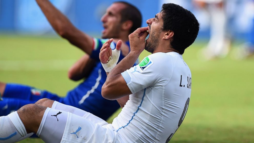 Luis Suarez of Uruguay and Giorgio Chiellini of Italy react after a clash during the 2014 FIFA World Cup match between Italy and Uruguay at Estadio das Dunas on June 24, 2014 in Natal, Brazil.  