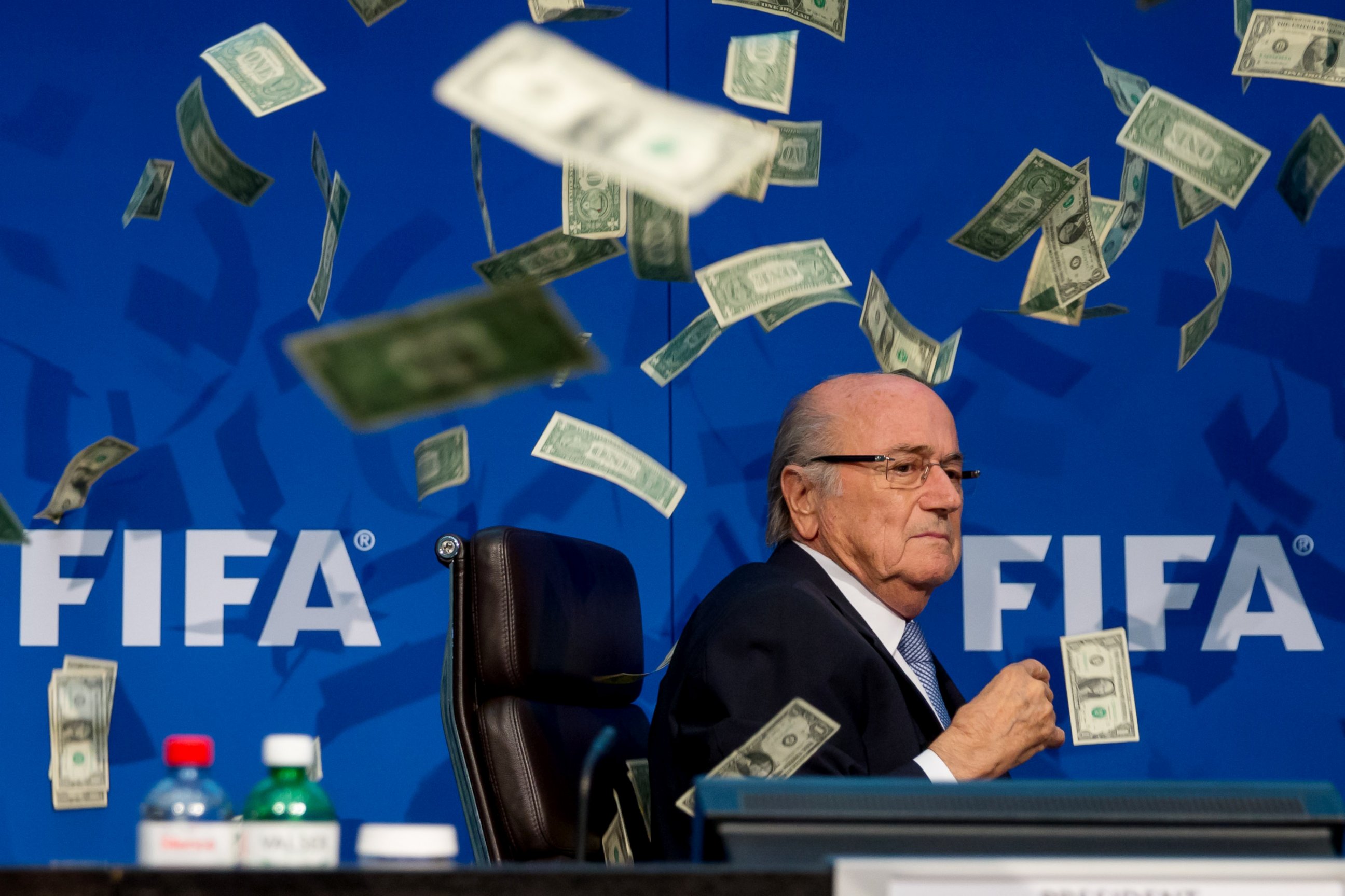 PHOTO: Comedian Simon Brodkin, not pictured, throws cash at FIFA President Joseph S. Blatter during a press conference at FIFA headquarters on July 20, 2015 in Zurich, Switzerland.