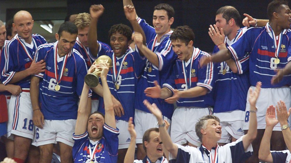 PHOTO: French forward Christophe Dugarry holds the FIFA trophy as the French team celebrates their victory over Brazil on July 12, 1998 at the Stade de France in Saint-Denis.