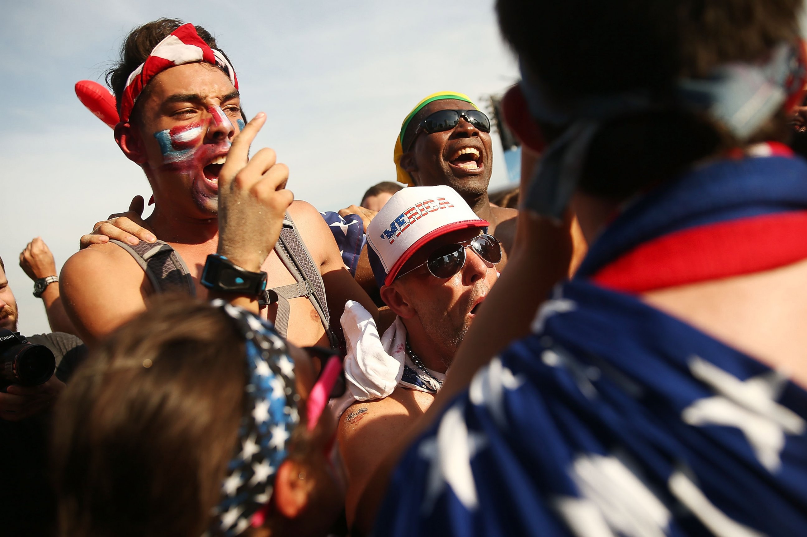 PHOTO: U.S. supporters celebrate advancing to the Round of 16 after their loss to Germany while watching the match at FIFA Fan Fest on June 26, 2014 in Rio de Janeiro, Brazil.