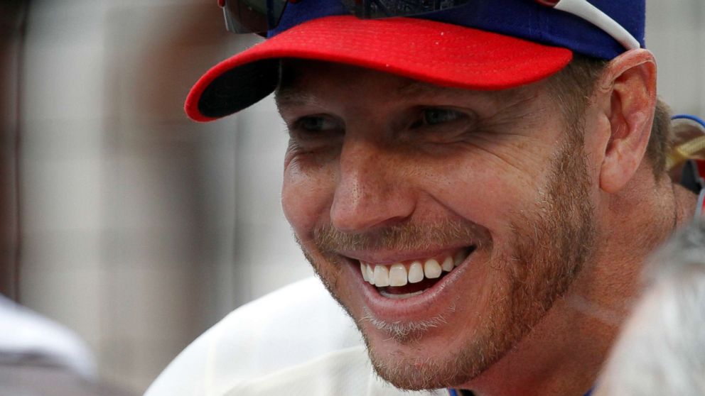 PHOTO: Philadelphia Phillies starting pitcher Roy Halladay smiles while sitting in the dugout before their game against the Chicago Cubs in Philadelphia, P.A., June 11, 2011. 