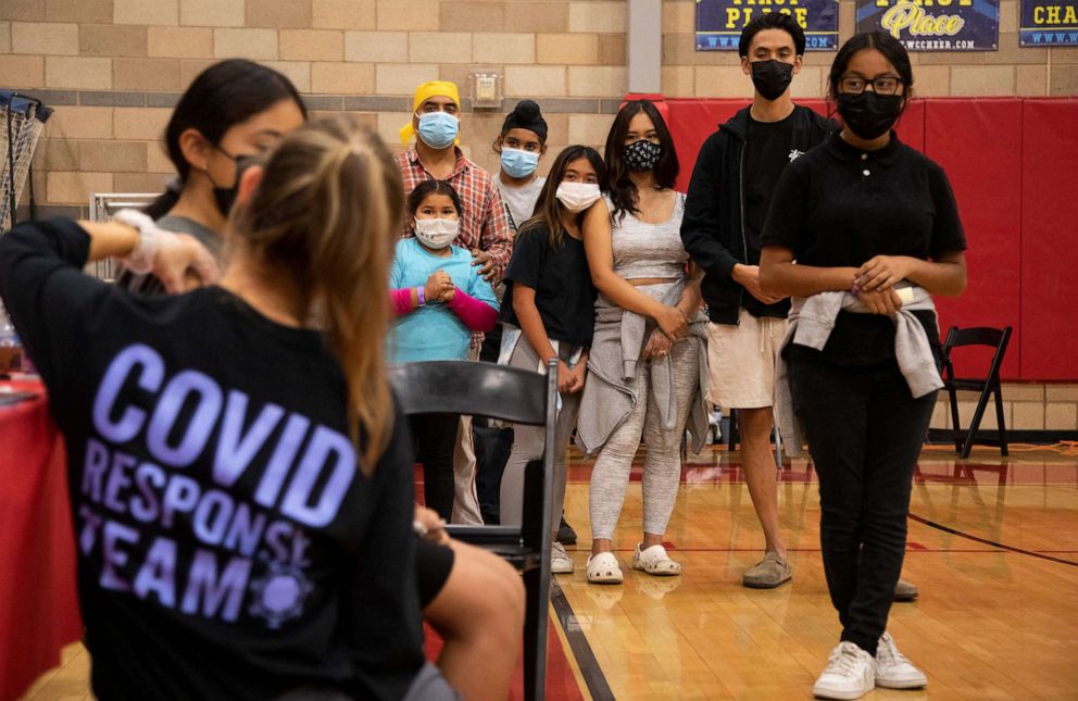 PHOTO: Children wait with their parents for the COVID vaccine at Arleta High School in Arleta, Calif., Nov. 8, 2021. 