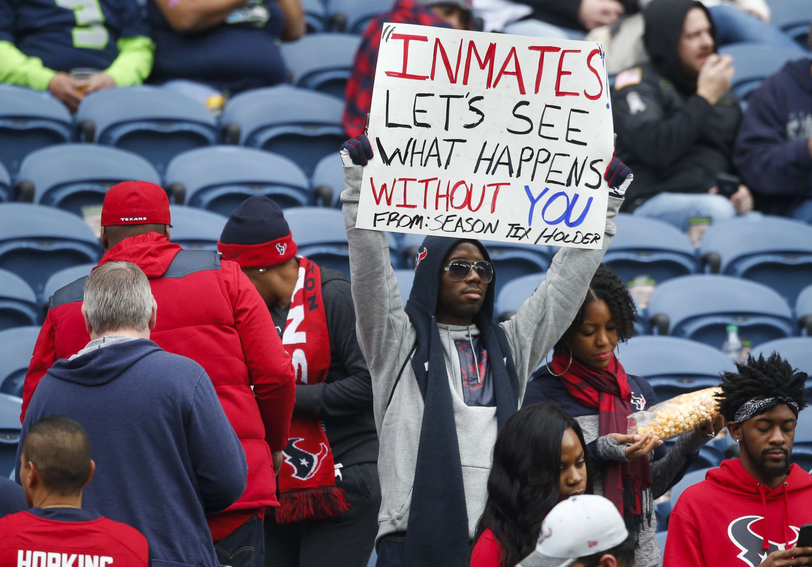 PHOTO: A Houston Texans fan holds a sign referring to Houston Texans owner Bob McNair's "inmates" comments before a game between the Houston Texans and Seattle Seahawks at CenturyLink Field on Oct. 29, 2017 in Seattle.