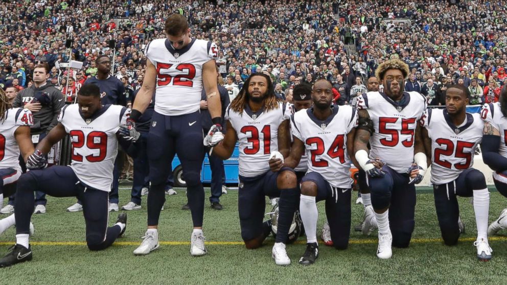 PHOTO: Houston Texans players kneel and stand during the singing of the national anthem before an NFL football game against the Seattle Seahawks, Oct. 29, 2017, in Seattle.
