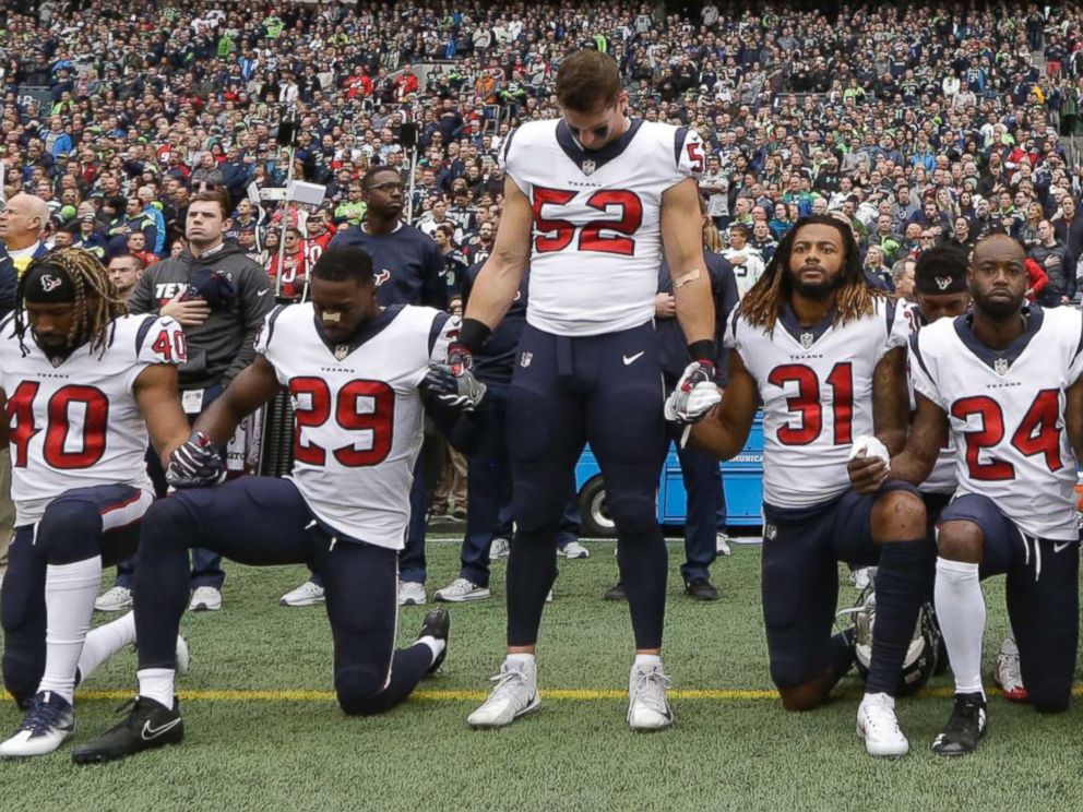 PHOTO: Houston Texans players kneel and stand during the singing of the national anthem before an NFL football game against the Seattle Seahawks, Oct. 29, 2017, in Seattle.