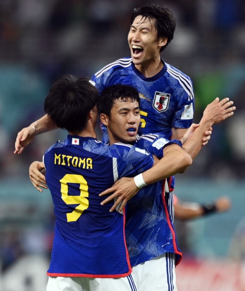 PHOTO: Japan's Kaoru Mitoma, Wataru Endo and Yuto Nagatomo celebrate after beating Germany in the World Cup Group E, Nov. 23, 2022.