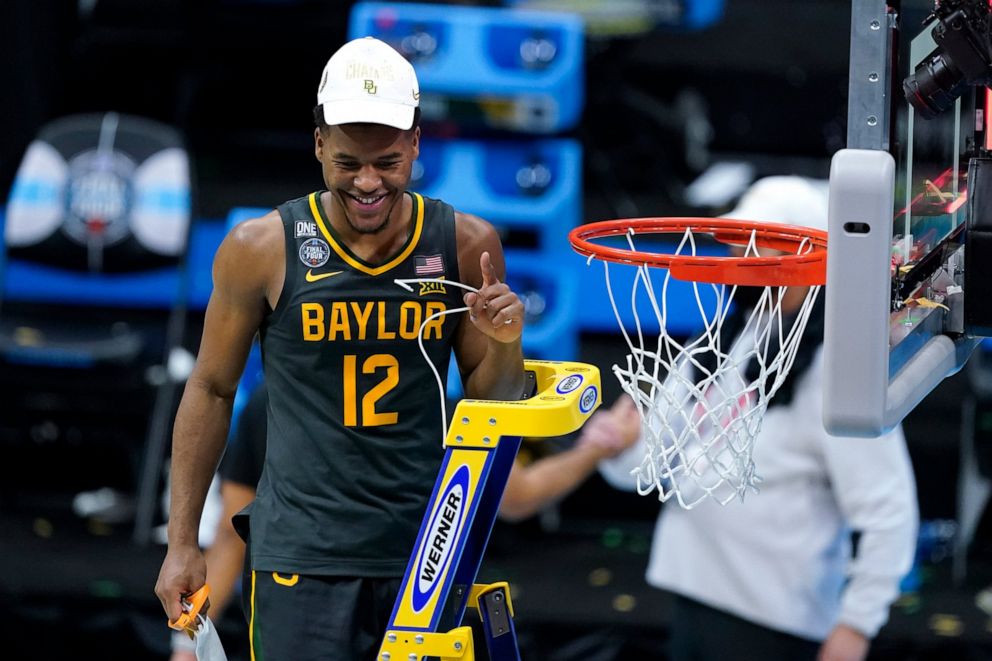 PHOTO: Baylor guard Jared Butler cuts down the net after the championship game against Gonzaga in the men's Final Four NCAA college basketball tournament, Monday, April 5, 2021, at Lucas Oil Stadium in Indianapolis.