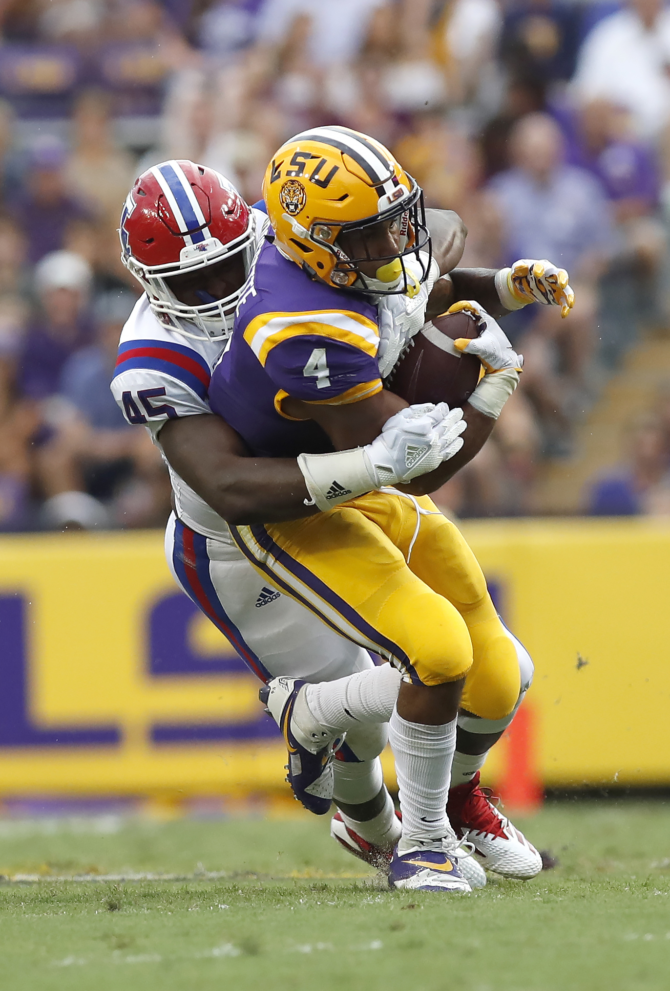 PHOTO: LSU running back Nick Brossette (4) is tackled by Louisiana Tech defensive end Jaylon Ferguson (45) in the first half of an NCAA college football game in Baton Rouge, LA., Saturday, Sept. 22, 2018.