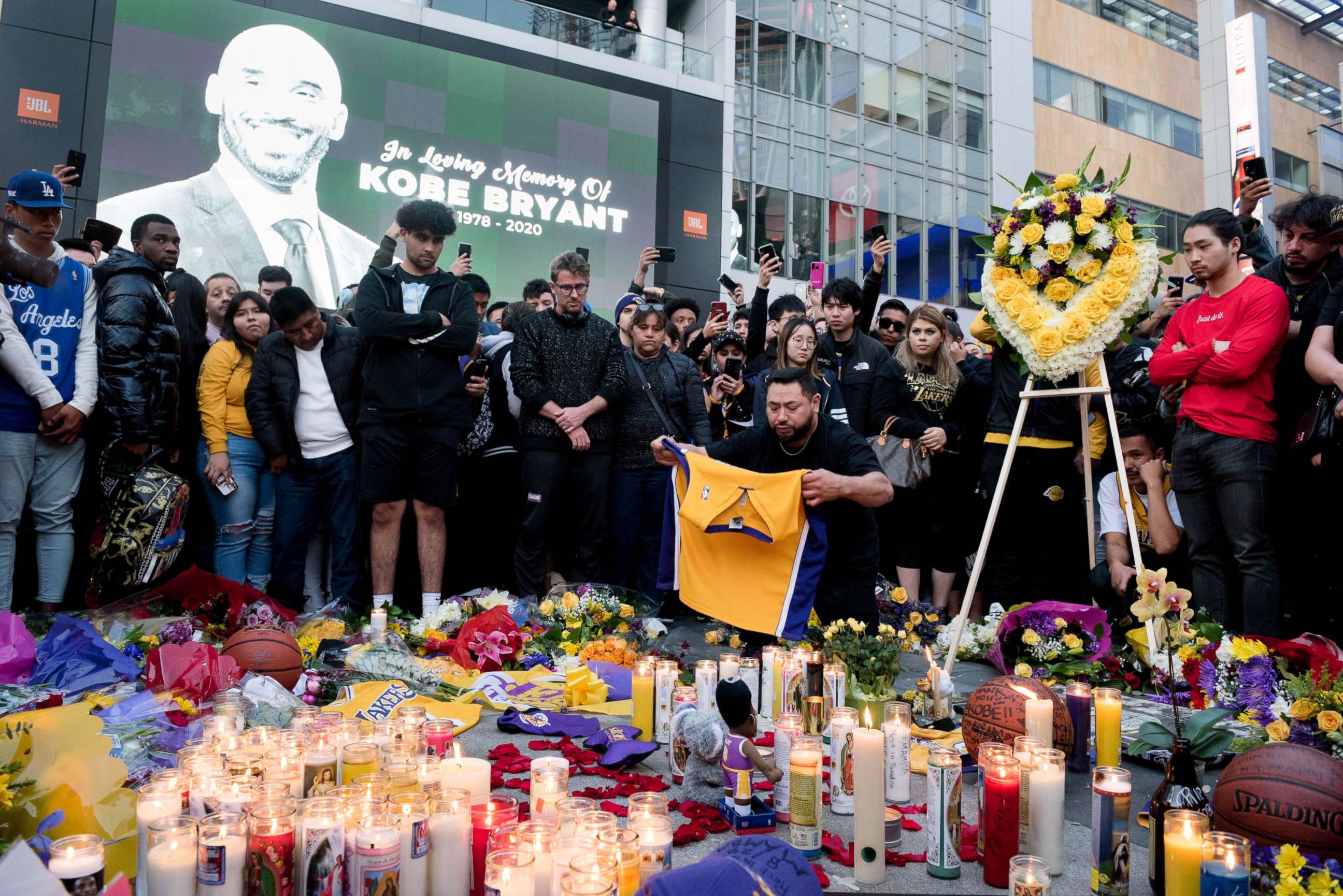 PHOTO: Fans gather at L.A. Live in Los Angeles to pay their respects to former Los Angeles Lakers guard Kobe Bryant who died in helicopter crash on Sunday. 
