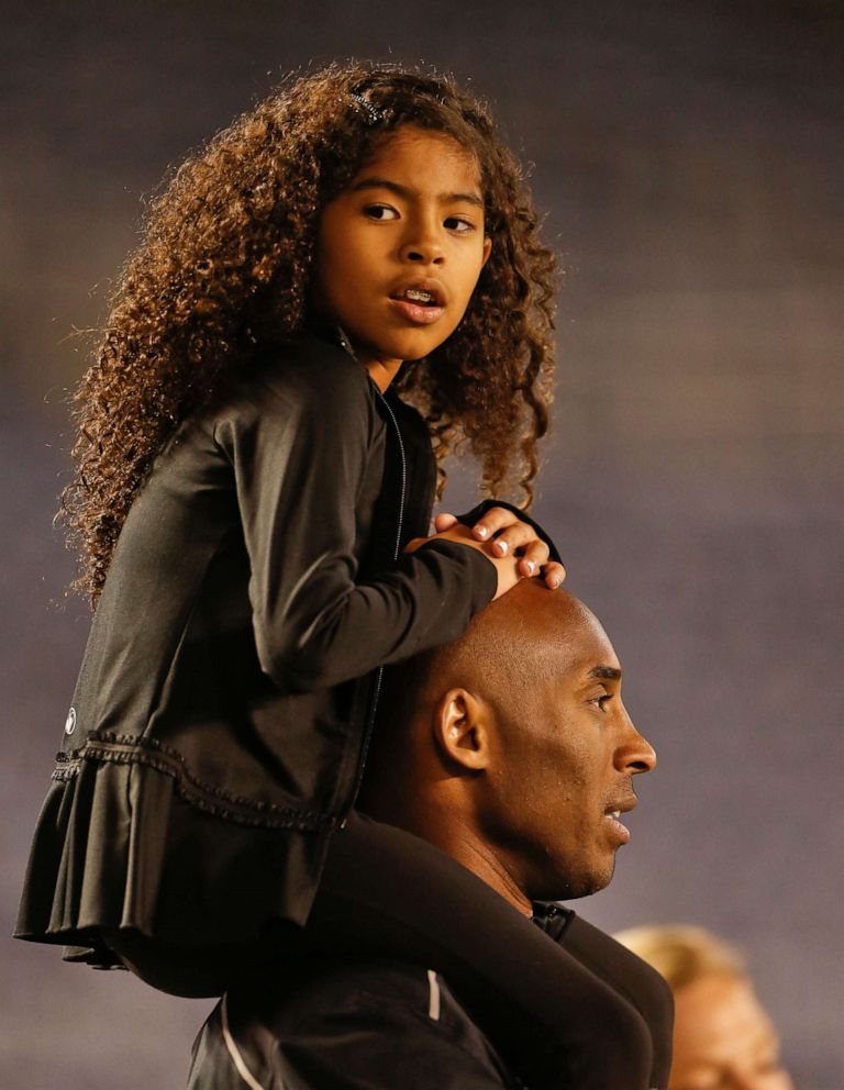 PHOTO: Gianna Maria-Onore Bryant sits on the shoulders of her father, Kobe, as they attend the women's soccer match between the United States and China Thursday, April 10, 2014, in San Diego. 