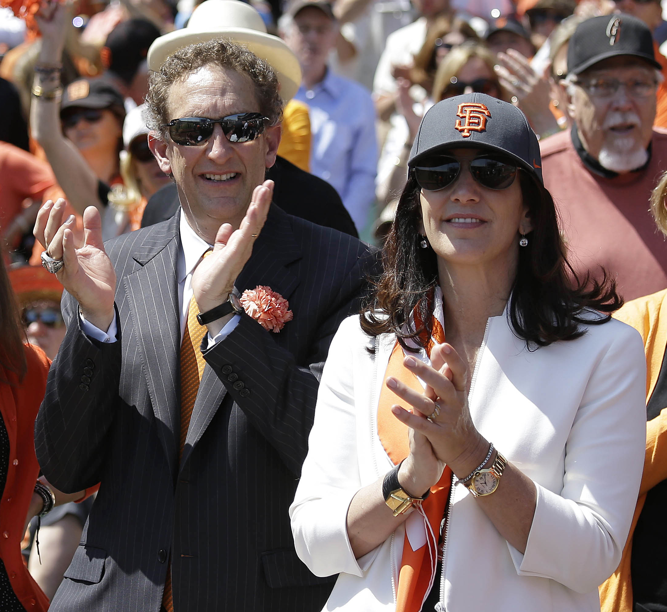 PHOTO: In this April 8, 2014, file photo, San Francisco Giants president and CEO Larry Baer, and his wife Pam, applaud before an opening day baseball game against the Arizona Diamondbacks, in San Francisco.