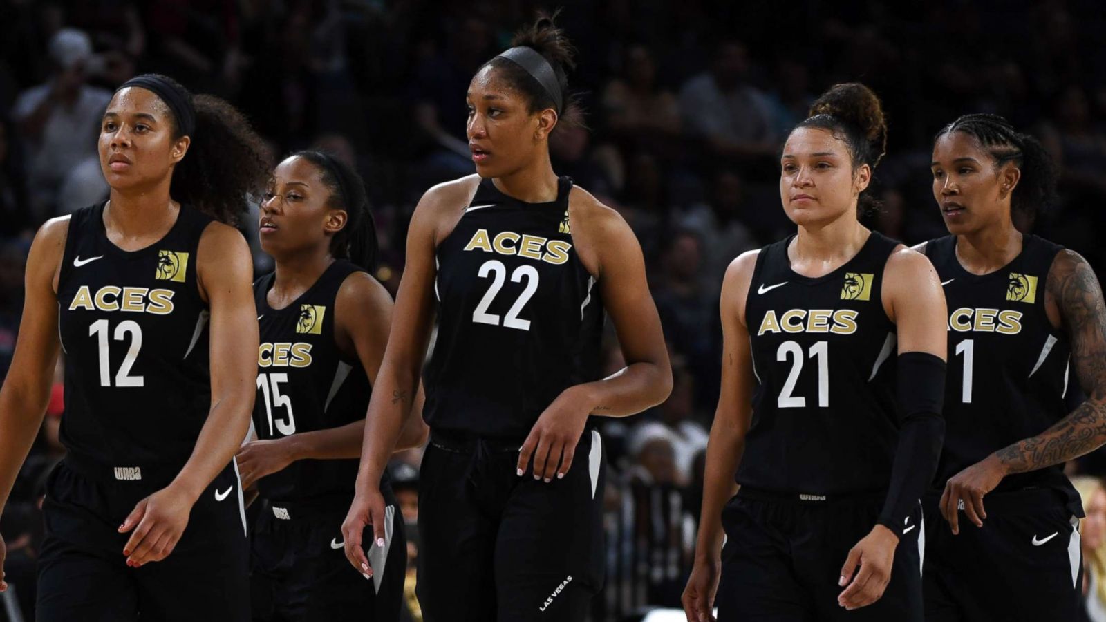 PHOTO: Nia Coffey #12, Lindsay Allen #15, A'ja Wilson #22, Kayla McBride #21 and Tamera Young #1 of the Las Vegas Aces walk on the court on May 27, 2018 in Las Vegas.