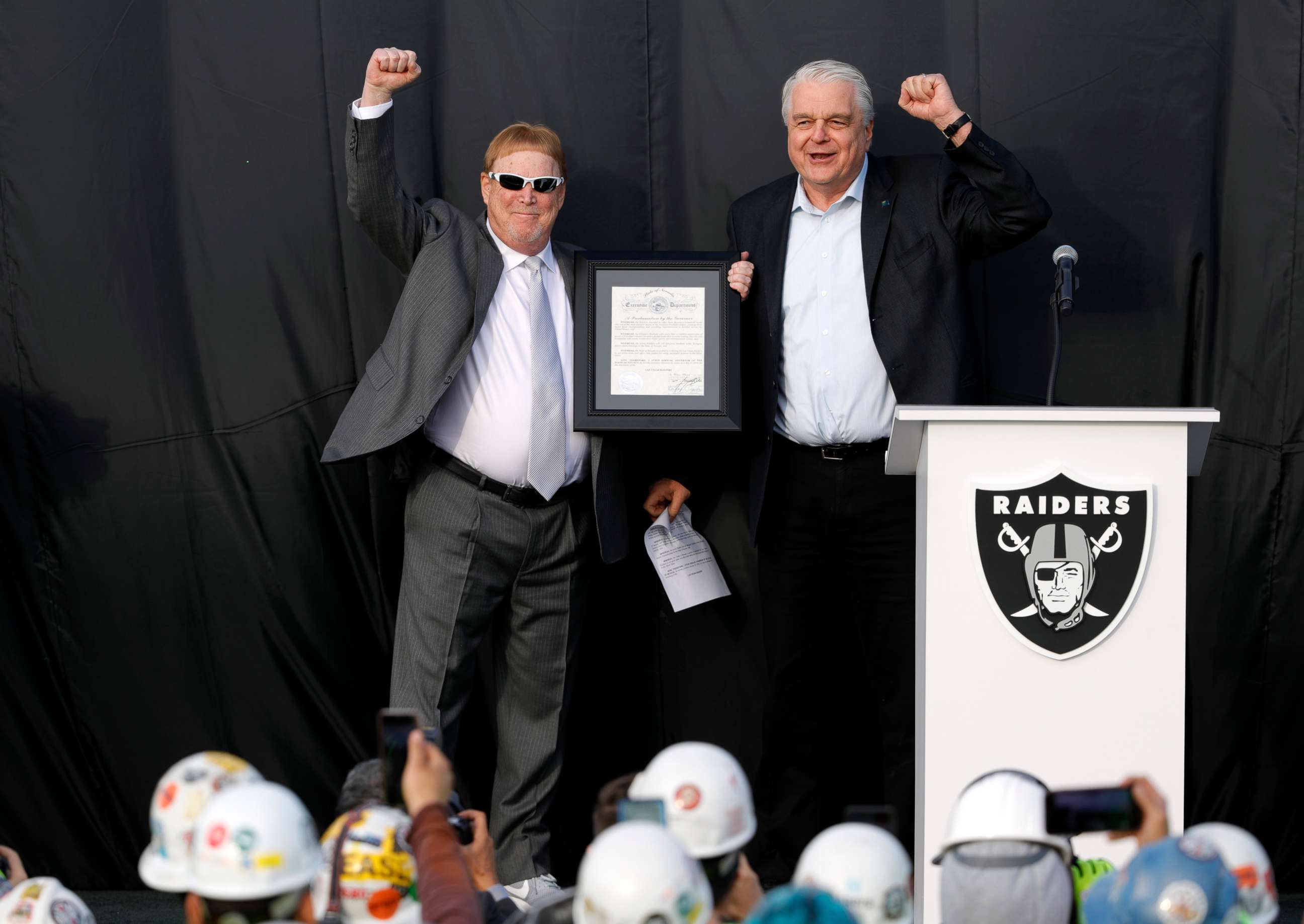 PHOTO: Las Vegas Raiders owner Mark Davis, left, and Nevada Governor Steve Sisolak celebrate during a news conference, officially renaming the Oakland Raiders to the Las Vegas Raiders, in front of Allegiant Stadium in Las Vegas, Jan. 22, 2020.