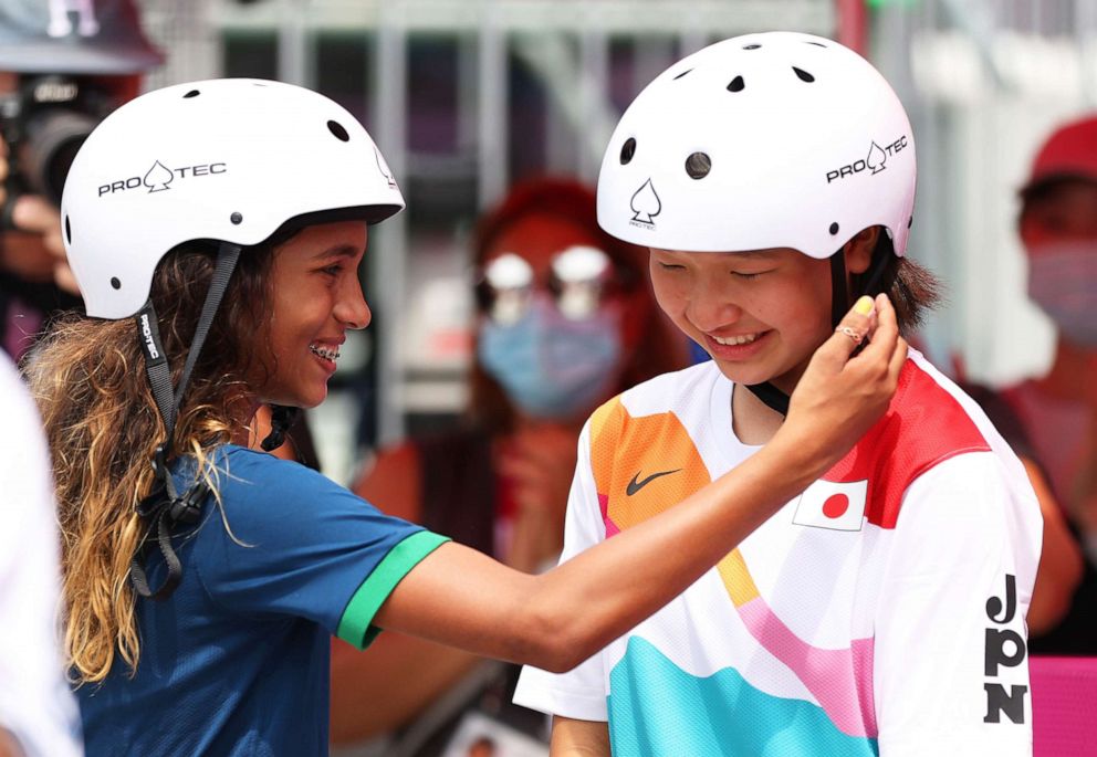 PHOTO: Rayssa Leal of Team Brazil puts her hand up to the face of Momiji Nishiya of Team Japan during the women's street final at the Tokyo 2020 Olympics at Ariake Urban Sports Park on July 26, 2021, in Tokyo.