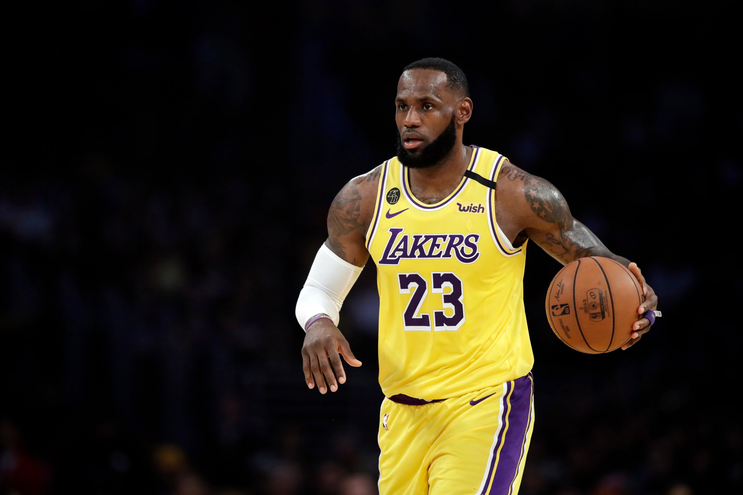 PHOTO: In this March 10, 2020, file photo, Los Angeles Lakers' LeBron James dribbles during the first half of an NBA basketball game against the Brooklyn Nets in Los Angeles.