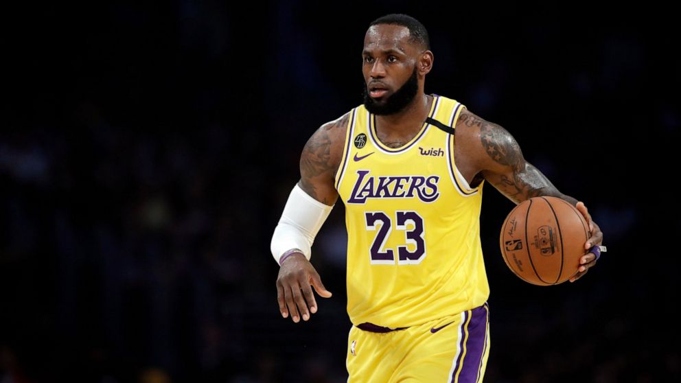 PHOTO: In this March 10, 2020, file photo, Los Angeles Lakers' LeBron James dribbles during the first half of an NBA basketball game against the Brooklyn Nets in Los Angeles.
