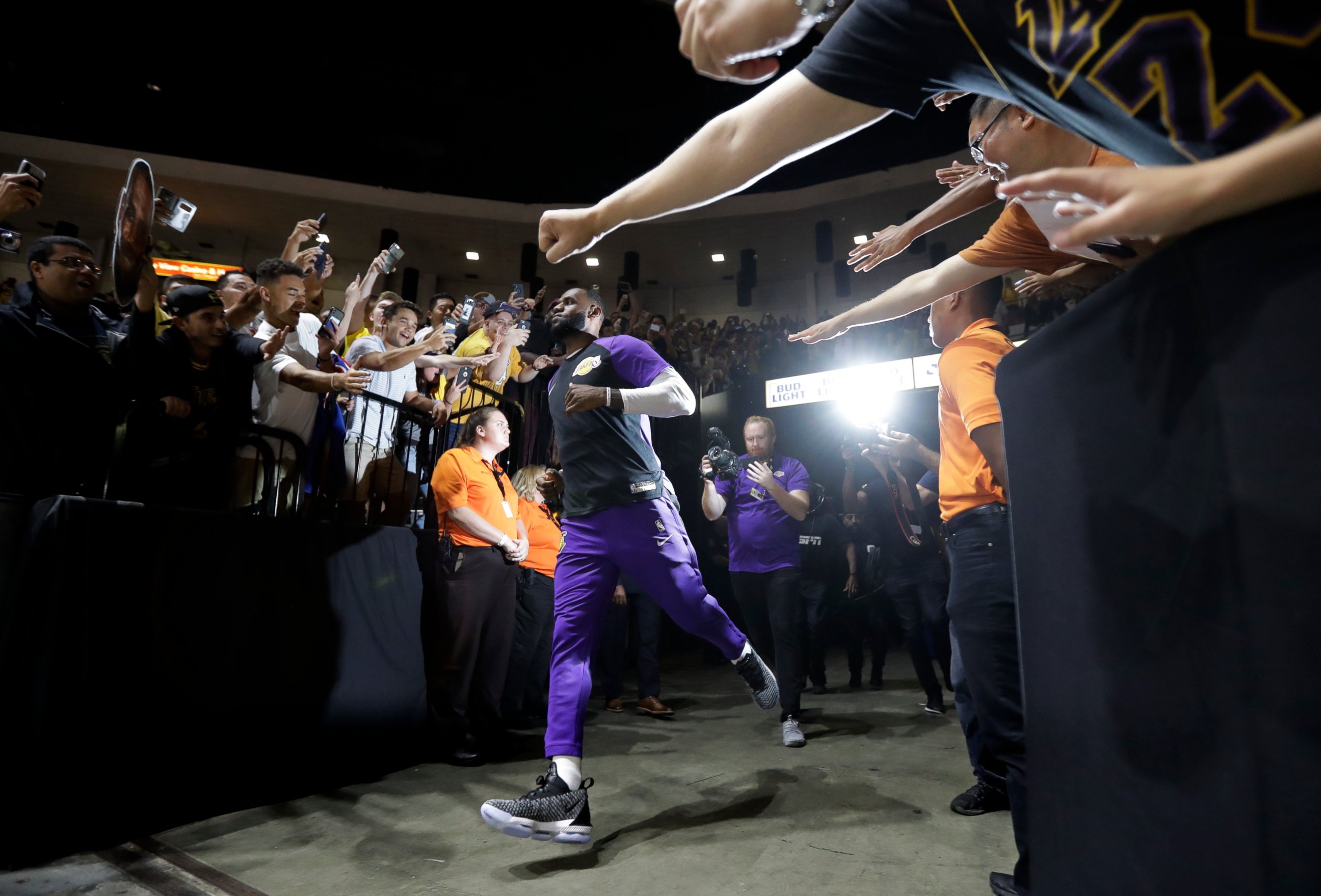 PHOTO: Los Angeles Lakers forward LeBron James runs past fans on his way to the court before an NBA preseason basketball game against the Denver Nuggets, Sunday, Sept. 30, 2018, in San Diego.