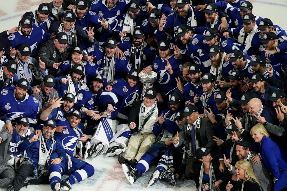 PHOTO: The Tampa Bay Lightning team poses with the Stanley Cup after Game 5 of the NHL hockey Stanley Cup finals against the Montreal Canadiens, Wednesday, July 7, 2021, in Tampa, Fla.