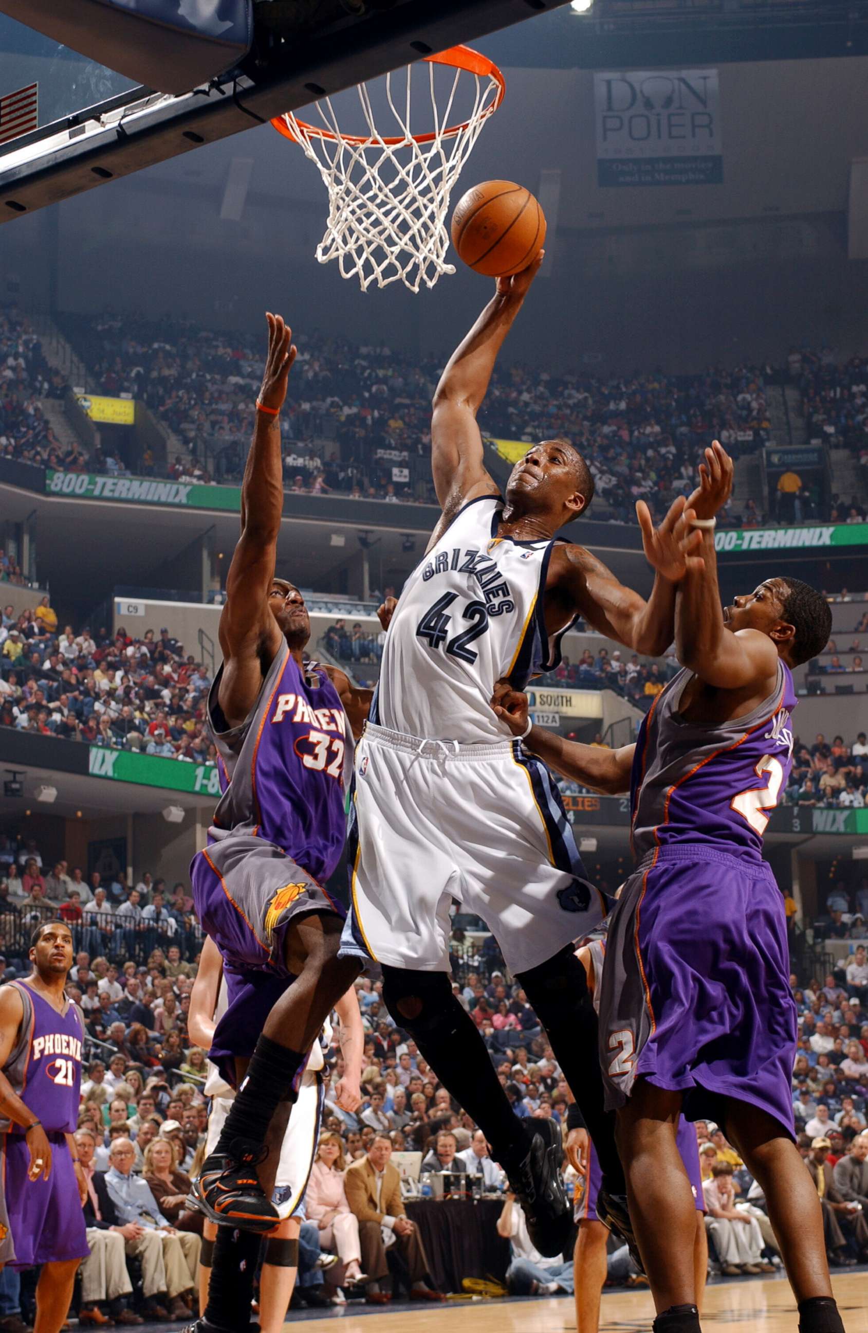 PHOTO: Lorenzen Wright, #42 of the Memphis Grizzlies, goes up for the dunk against the Amare Stoudemire and Joe Johnson of the Phoenix Suns in Game three of the Western Conference Quarterfinals during the NBA Playoffs in Memphis, Tenn., April 29, 2005.