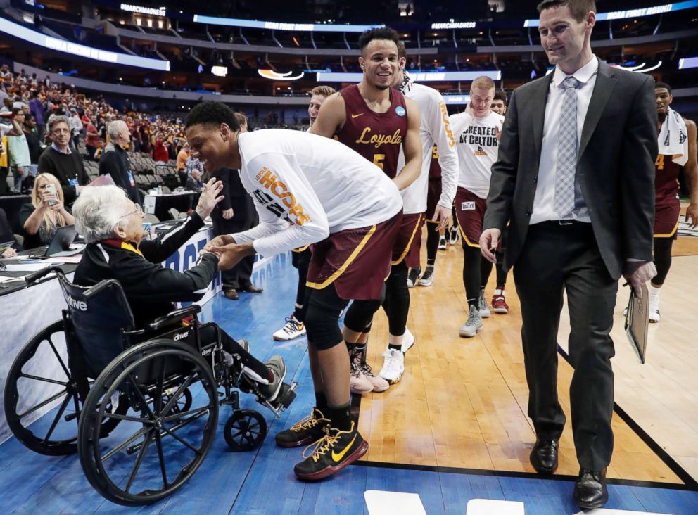 PHOTO: Sister Jean Dolores Schmidt, left, greets the Loyola-Chicago basketball team as they walk off the court after their win over Miami in a first-round game at the NCAA college basketball tournament in Dallas, March 15, 2018.