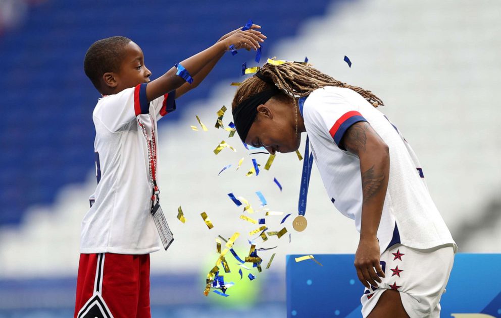 PHOTO: Jessica McDonald of the USA celebrates with her son following her team's victory in the 2019 FIFA Women's World Cup France Final match, July 7, 2019, in Lyon, France. 