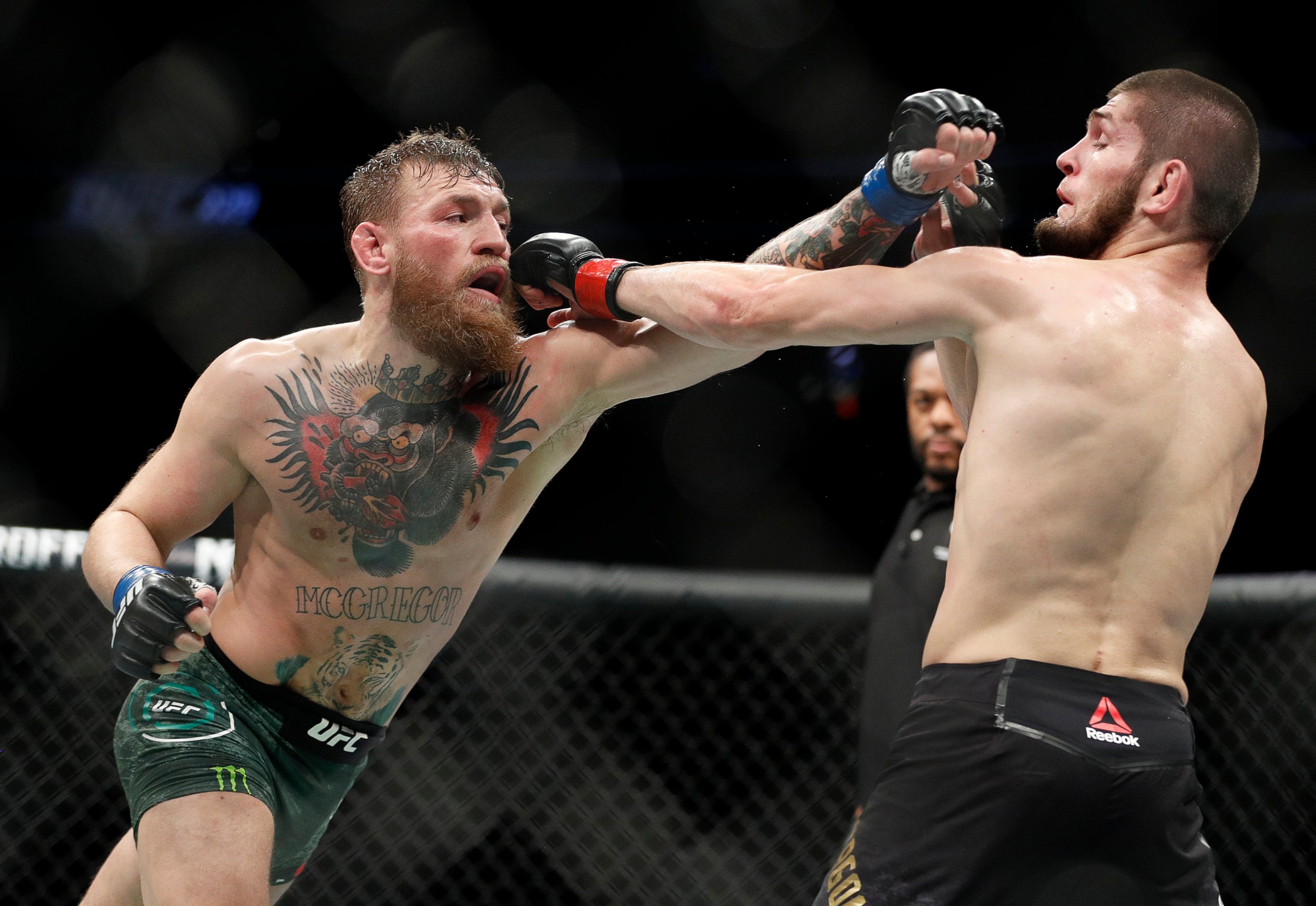 PHOTO: Conor McGregor, left, and Khabib Nurmagomedov throw punches during a lightweight title mixed martial arts bout at UFC 229 in Las Vegas, Saturday, Oct. 6, 2018.